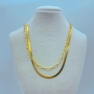 Double layered gold snake bone and paperclip necklace displayed on a mannequin