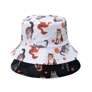 Reversible bucket hat for women with cute cat print in black and white cotton canvas