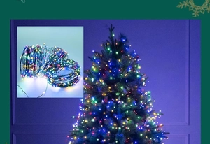 Detail of colorful LED Christmas tree fairy lights on dark green copper wire