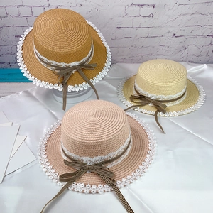 Detailed trio of flat top straw hats with white lace edges and plaid ribbon bows