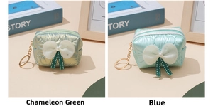 Quilted nylon coin purse detail with white bow and gold keychain in blue and green