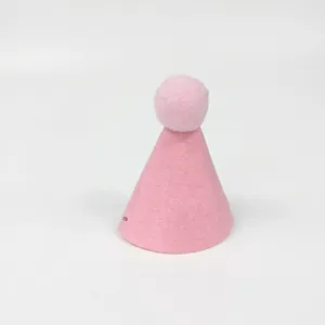 Close-up of pink felt pet birthday hat with soft pom-pom detail for party decor