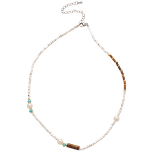 Ethic beaded necklace with silver, tiger eye stone and pearls on a white background
