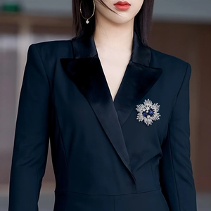 Vintage silver flower brooch with blue waterdrop crystals on a navy suit lapel
