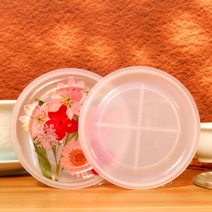 Macro detail of a round silicone resin mold with a floral dried flower coaster sample