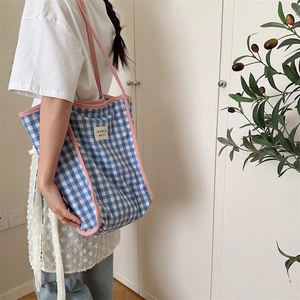 Detail of blue and white checkered canvas tote bag with pink piping and Borakka label