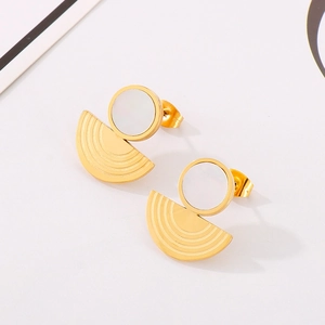 Macro shot of minimalist gold stainless steel earrings with white geometric shell inlays