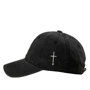Distressed black baseball cap with white cross embroidery and washed cotton finish