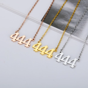Detailed view of gothic 444 number necklaces in rose gold, gold, and silver steel finishes