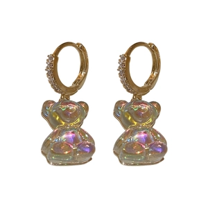 Golden hoop earrings with zircon pavé and iridescent bear charms in a front view