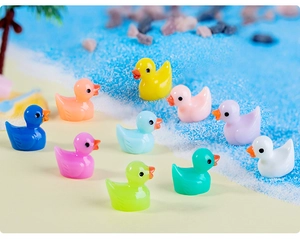 Detailed view of colorful miniature resin ducks on a beach-themed micro landscape decor