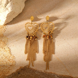 Detail of vintage heart-shaped earrings with natural stone beads and long metal tassels