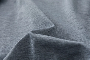 Macro shot of heather grey knit fabric showing soft texture and premium wrinkle-free weave