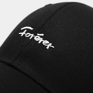 Detailed close-up of white Forever letter embroidery on a black cotton baseball cap