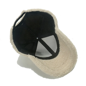 Detail view of winter lambswool baseball cap interior with mesh lining and strap