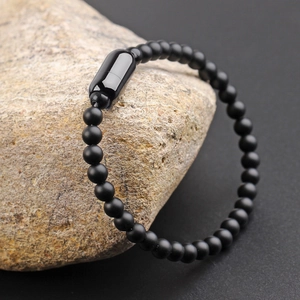 Men's matte black beaded bracelet featuring a polished stainless steel capsule clasp