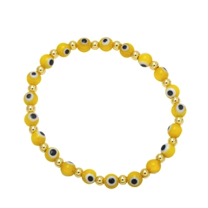 Detail of yellow evil eye beaded bracelet with gold spacers on white background