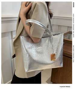 Silver crocodile pattern tote bag shown in a professional lifestyle fashion shoot