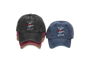 Close-up of multicolor embroidery with Surf Wave text and surfboard on cotton caps