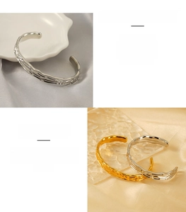 Detail of irregular wave texture on gold and silver stainless steel cuff bangles