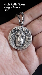 Macro shot of high-relief lion head pendant with intricate silver metal textures