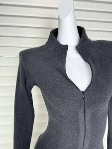 Close-up of slim-fit gray thermal top with a mock neck and metallic zipper detail