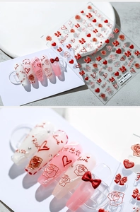 Detail of 3D embossed nail stickers featuring red roses, hearts and romantic text