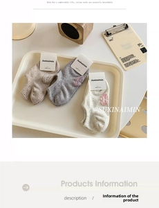 Detailed macro view of three-piece combed cotton low-cut socks with branded embroidery patches