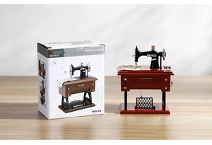 Vintage sewing machine music box with retro wood grain finish and white gift packaging