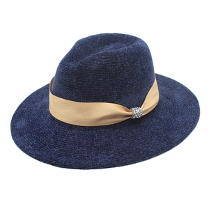 Detail of navy knit fedora hat with chenille texture and rhinestone buckle ribbon