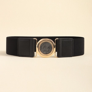 Detail of black elastic belt featuring a golden round buckle with shimmering black inlay