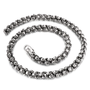 Gothic punk skull chain necklace in silver-toned stainless steel on white background