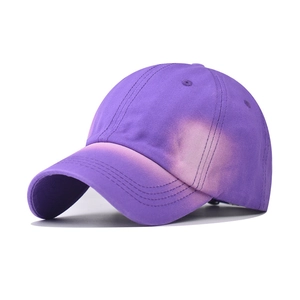 Close-up of purple washed denim baseball cap with faded vintage texture and twill fabric