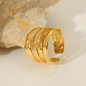 Minimalist irregular wave layered gold open ring on natural stone texture background