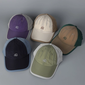 Flat lay of multiple quick-dry checkered baseball caps with AB embroidery in diverse colors