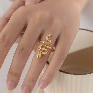 Close-up of gold-plated stainless steel snake ring with realistic scale texture on model