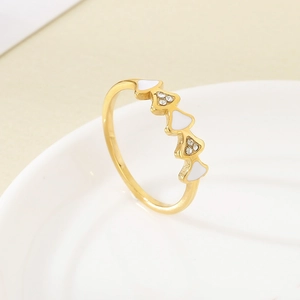 Détail d'une bague en acier inoxydable plaqué or 18K avec émail blanc et zircons