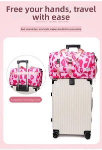 Pink leopard print travel bag shown attached to a suitcase handle for easy carrying