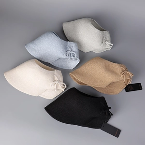 Detail view of woven straw sun visors with bow accents in five various colors