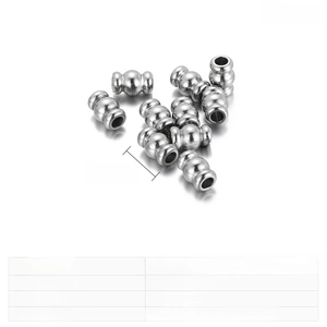 Detailed view of 9x5mm stainless steel corrugated cylinder beads with polished finish
