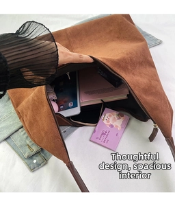 Interior view of large capacity brown suede tote bag showing space for tablet and books