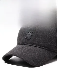 Macro detail of charcoal grey baseball cap showing textured twill fabric and B leather patch