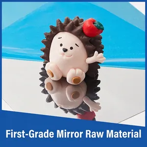 Hedgehog stainless steel cookie cutter with red apple detail on reflective surface