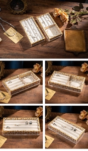 Detail view of acrylic jewelry organizer with white velvet lining and gold leaf pattern