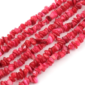 Macro view of irregular red shell stone beads for DIY jewelry making and necklace crafts