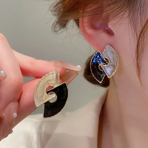 Detailed view of vintage gold-framed black and marble enamel interlocking earrings