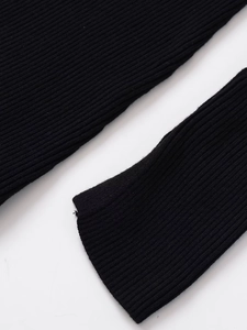 Detailed close-up of the black ribbed knit fabric texture and high-quality stitching