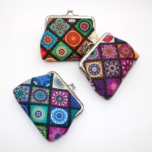 Close-up of mandala pattern coin purses with metal clasps in three vintage colors
