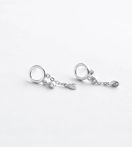 Detailed close-up of silver drop earrings featuring a circular stud and zircon water drop charm