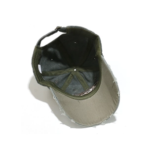 Detail view of cotton baseball cap interior with vintage frayed brim and metal buckle